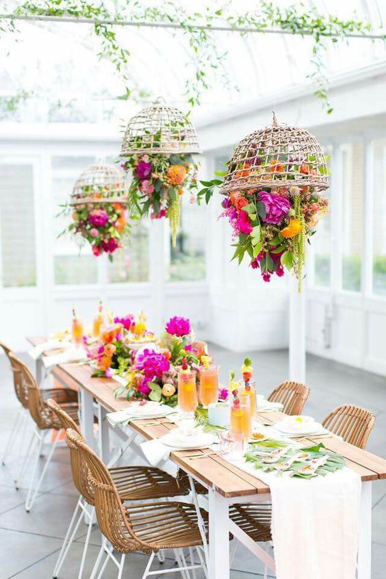 if the weather is bad, go to the sunroom and rock much greenery, super bold blooms and wicker touches to make everyone feel outdoors