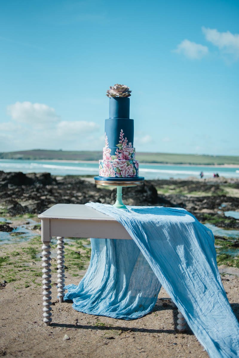 The wedding cake was a navy one, with handpainted florals, a succulent on top and blue fabric