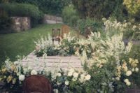 12 a chic garden wedding altar with white and neutral blooms and much greenery for a lush look