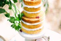 12 a naked wedding cake topped with pomegranates, grapes and cherries for a boho wedding