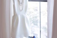 12 a sleek sleeveless mini dress with a scallop edge, layered necklaces and blue shoes for something blue