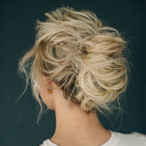 a very messy updo with locks down and much volume for a very casual and boho look