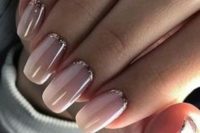 12 nude nails with a touch of rose glitter for a chic and glam feel at the wedding