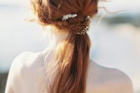 13 a cute twisted ponytail with waves and a texture spruced up with some delicate hairpieces