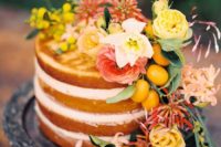 13 a naked wedding cake topped with yellow, pink and white blooms and kumquats for a Mediterranean wedding