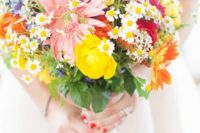 13 a very colorful wedding bouquet in pink, fuchsia, yellow and purple with a messy wildflower-inspired look