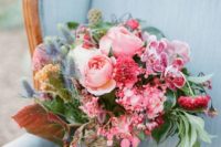 14 a super colorful wedding bouquet in the shades of pink and blue with various leaves