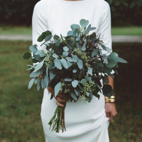 a minimalist bridal bouquet made of different types of eucalyptus is a simple and bold idea to stand out