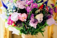 15 a super colorful wedding bouquet in purple, mauve, blue, red and pink with a burlap wrap for a bold wedding
