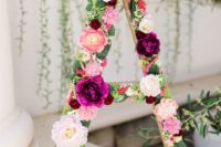 15 make a cool shower decoration using a letter and some faux greenery and blooms to attach to it