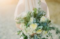 16 a large textural bouquet with neutral and blue flowers and greenery plus ribbons