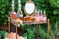16 an elegant bar cart with oversized paper flowers and lots of drink served looks very refined and chic