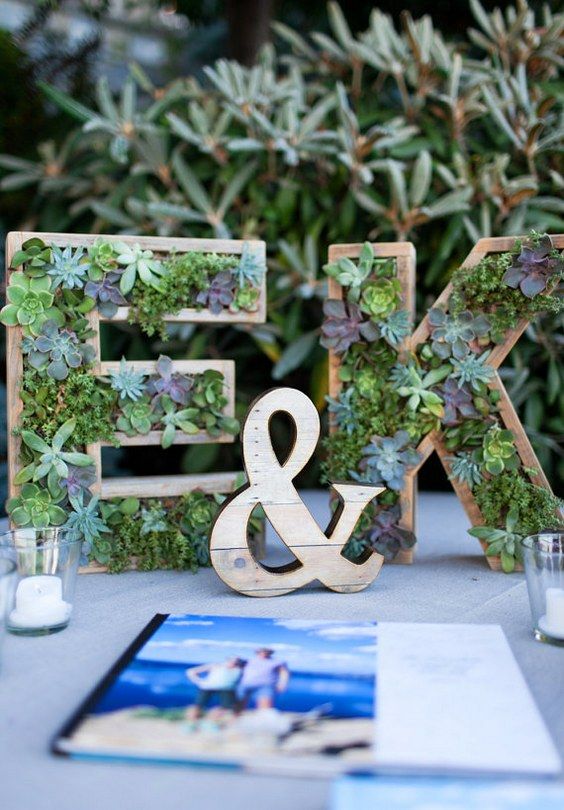 wooden monograms with succulents planted inside are a creative and modern wedding decor idea