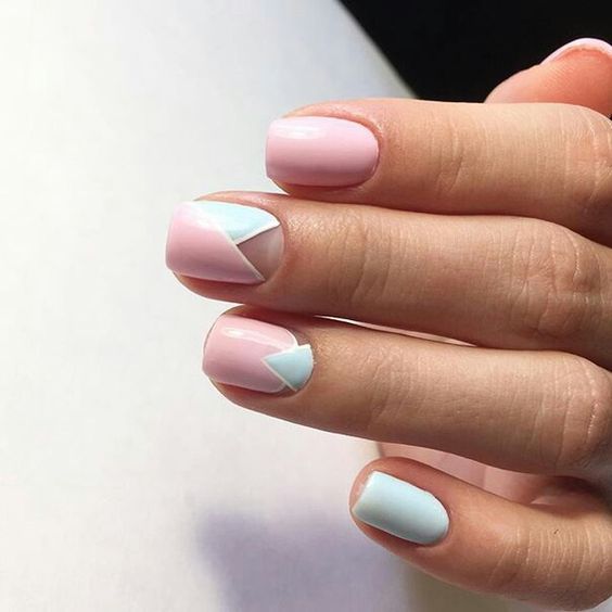 light blue and light pink geometric nails with sme negative space for a colorful summer touch
