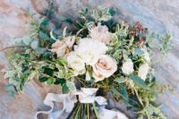 18 a light-colored wedding bouquet with white and blush blooms and much greenery