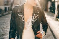 19 a rock n roll bride in a romantic dress, a black studded jacket and with a cool updo