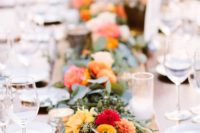 20 a lush eucalyptus and orange and red blooms table runner over a lace one for a bold touch