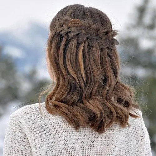 a waterfall braid hairstyle with some waves down for a boho chic feel