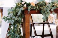 21 a lush eucalyptus table runner with some blush and peachy blooms is a gorgeous idea for summer