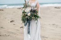 21 a moody coastal wedding bouquet with lush greenery reminding of the sea and a king protea