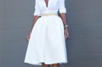 21 a white button down and a full pleated skirt, an embellished belt and metallic shoes