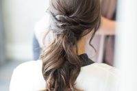 22 a low twisted ponytail with some wavy locks down and wavy ends is a chic and casual idea