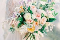 22 a lush oversized wedding bouquet in the shades of blush, muted yellow, mauve and cream plus greenery