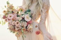 22 a pastel-colored wedding bouquet with red, blush, rust blooms and some greenery