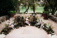 22 a textural wedding altar of various herbs, leaves, blush and white blooms created on a terrace looks very romantic