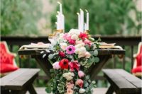 23 a lush greenery table runner with red, pink and blush flowers integrated looks colorful and chic