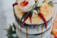 23 a semi naked wedding cake with honey drip, blush blooms and lisianthus on top