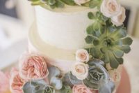23 an ombre wedding cake with blush blooms and succulents for decor