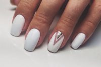 23 matte white nails and a single accent nail with silver sequins for a super elegant yet minimalist look