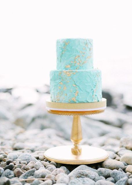 a textural turquoise wedding cake with gold leaf for a colorful beach wedding