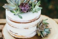 25 a naked wedding cake topped with succulents to give it a modern rustic look