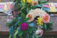 25 a super lush greenery table runner with yellow, blush and fuchsia flowers is a bold idea for summer