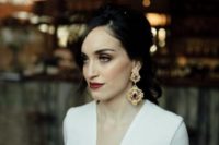 26 a moody bride rocking statement vintage earrings of gold and rubies and a matching lip