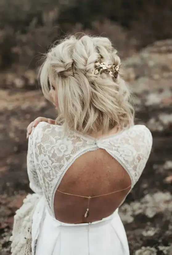 a catchy blonde medium half updo with large twisted braids and gold floral hairpins is a chic and cool idea