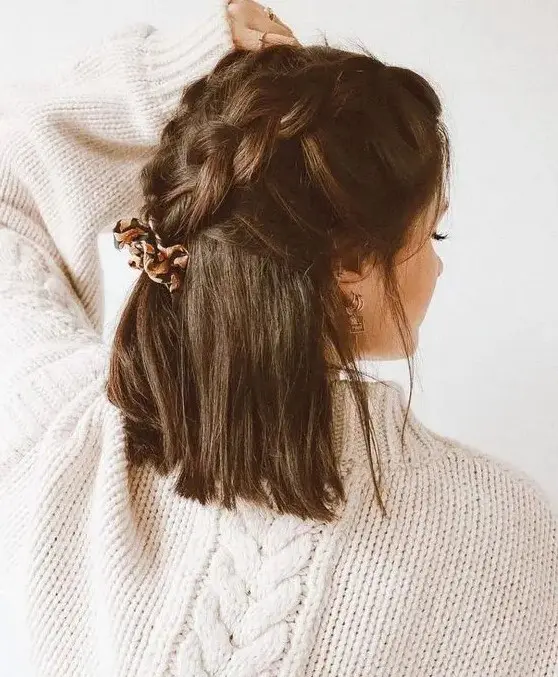 a creative dark brown half up wedding hairstyle with large braids on top and hair down is a cool idea for a boho bride