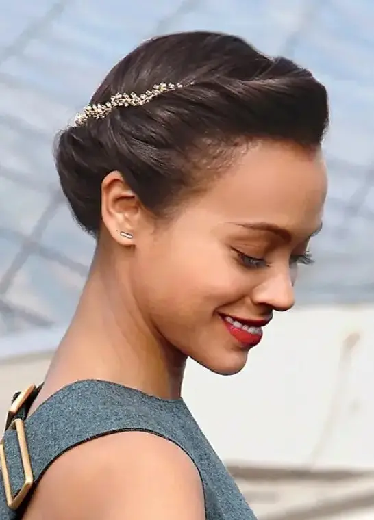 a laconic low updo with a small volume on top and a gold branch wedding headpiece for an accent