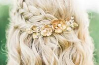 a lovely blonde half updo with a volume on top, a double side braid, a hairpiece and waves down is chic
