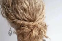 a low bun with curly hair and locks down is an exquisite option to rock at a wedding