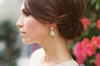 a sleek top and a small side low bun for a timelessly elegant look is suitable for medium and even short hair