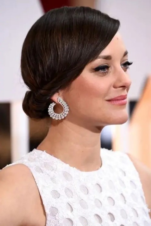 a sleek twisted low updo is a chic idea with a retro touch that will fit medium length hair
