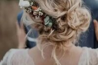 messy and loose wedding low updo with waves and locks down and with a floral accent – neutral and blush blooms and greenery