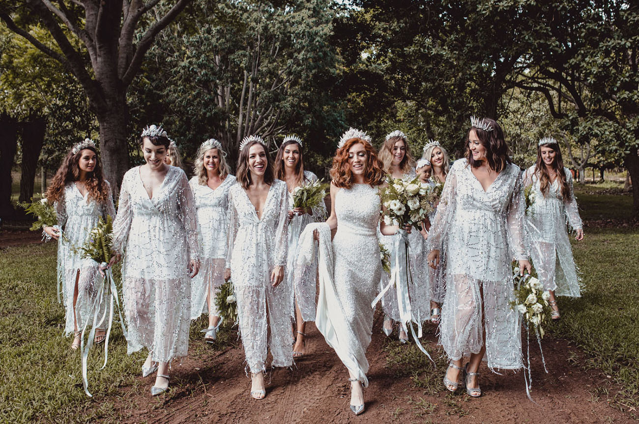 The bridesmaids were wearing silver dresses with illusion skirts and crowns