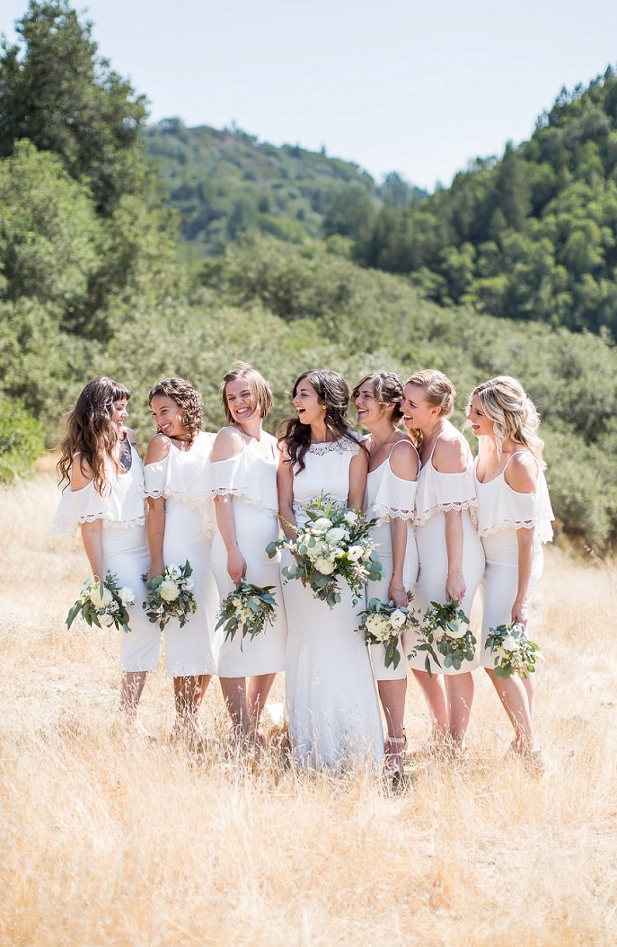 The bridesmaids were wearing white midi dresses with a lace trim and a cold shoulder for a cute look