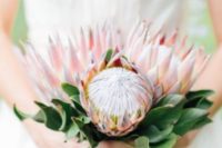 02  a wedding bouquet of three pink king proteas and some leaves for a classic look