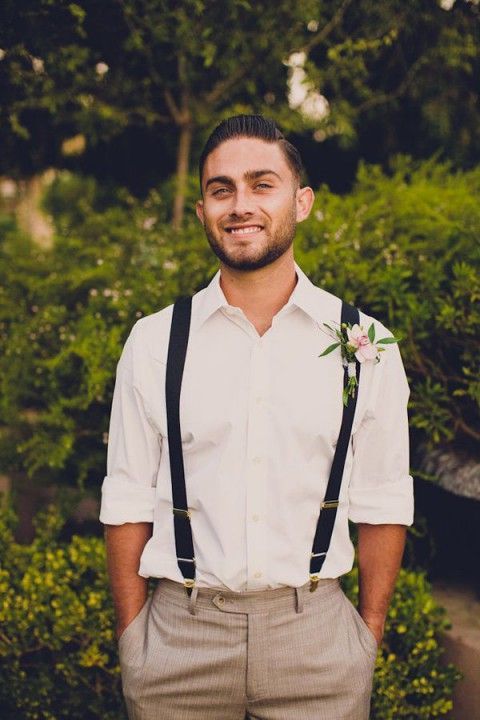 beige printed pants, a white shirt, black suspenders for a comfy casual groom's look