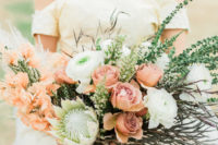 03 Her bouquet was done with white and rust-colored blooms, greenery and herbs plus king proteas